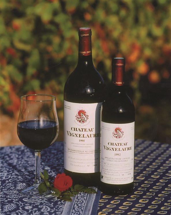 Two bottles of Château Vignelaure red with a filled glass